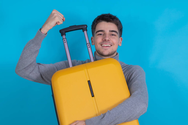 young man with suitcase isolated on background - Valokuva, kuva