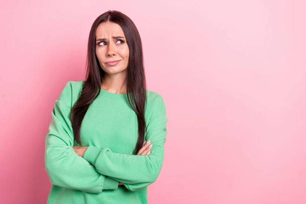 Photo of young minded intelligent ponder thoughtful woman wearing green pullover folded hands look mockup isolated on pink color background. - Foto, afbeelding