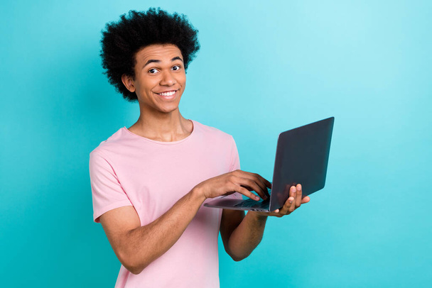 Photo of positive funny smiling young programmer it developer studying code python typing computer isolated on aquamarine color background. - Фото, зображення