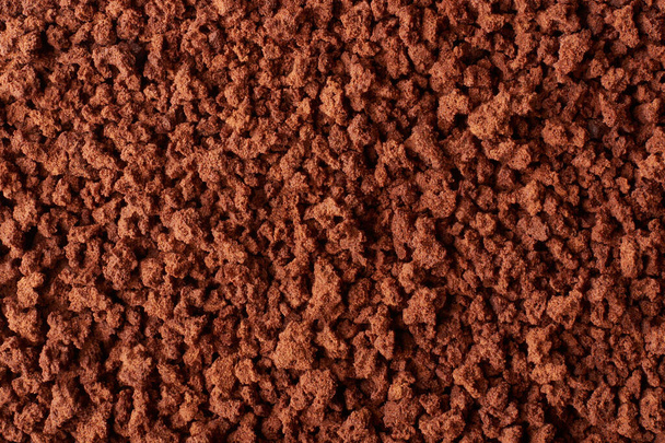 close-up macro view of ground coffee, coffea arabica, roasted coffee beans that ground to be brewed, full frame food background - Foto, afbeelding
