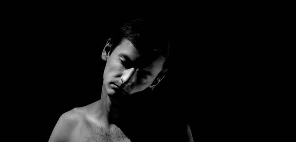 foto expresiva, retrato en blanco y negro de un chico, con luz dura - Foto, Imagen