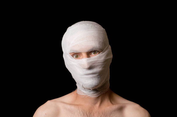 portrait of a guy head wrapped in a bandage - Photo, Image