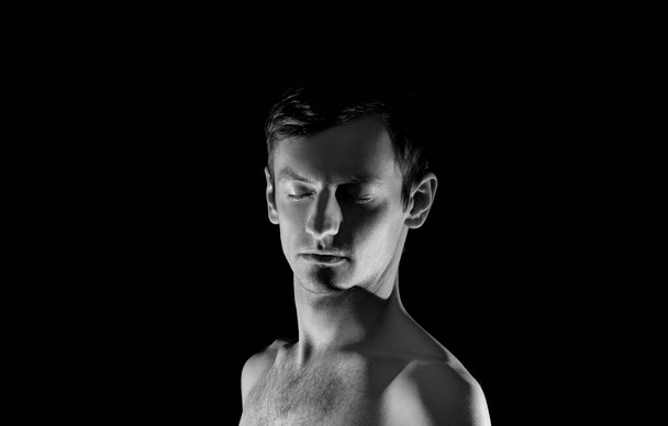 black and white photo portrait of a guy, in dramatic lighting  - Photo, Image