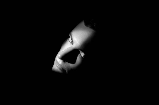 dramatic portrait of a man on black background - Photo, Image