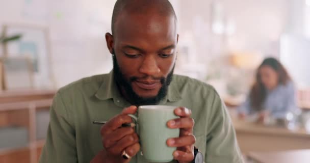 Man smell coffee, cup and aroma for inspiration while working, design and planning in startup. Creative black man, cafe and fragrance of drink to start morning at graphic design business in Atlanta. - Materiał filmowy, wideo