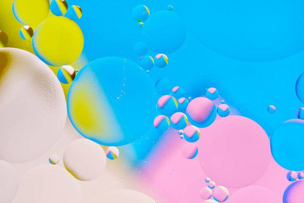 Bright abstract, multicolored background with oil circles.With blue, pink and beige color. - Foto, afbeelding