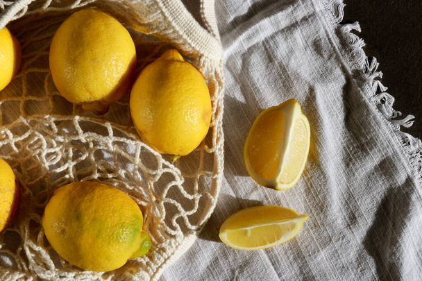 upper view of fresh lemons in cotton eco string bag  - Фото, зображення