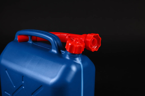 New blue plastic canister on black background, closeup - Foto, Bild
