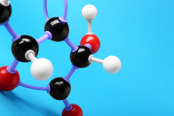 Closeup view of vitamin C molecule on light blue background, space for text. Chemical model - Foto, Imagem