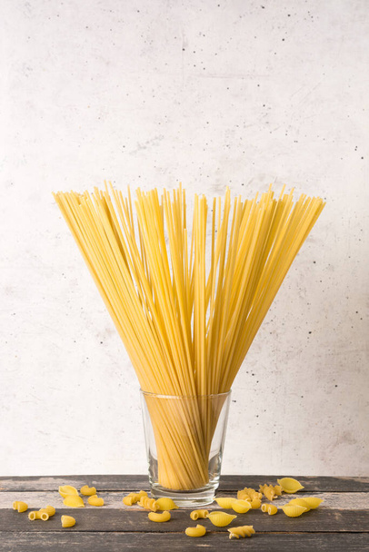 variety of uncooked pasta on a table top, food and diet concept, copy space - Photo, image