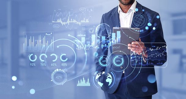 Black businessman using tablet in hand, double exposure with glowing forex analysis dashboard, stock market candlesticks with bar chart and statistics. Concept of big business data - Photo, Image