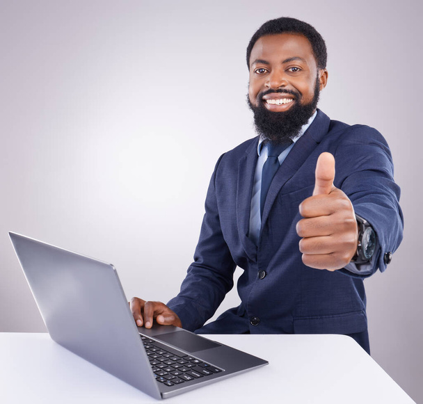 Black man, laptop and thumbs up isolated on a white background portrait for winning, online success and thank you. Happy business person or winner with yes, like and vote sign on computer in studio. - Fotoğraf, Görsel