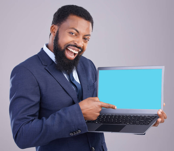 Laptop, green screen and black man isolated on gray background portrait for business software mockup or product placement. Wow, excited or happy digital person with computer website mock up in studio. - Fotó, kép