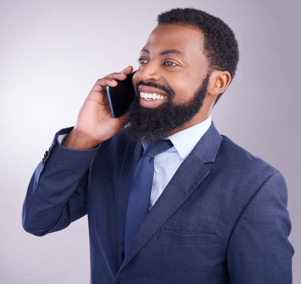 Corporate black man, phone call and smile in studio for business conversation, hello and chat. Happy executive, male model and cellphone communication for mobile networking, contact and talk feedback. - Фото, изображение