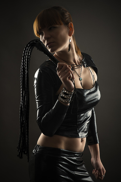 Sexy woman with whip in hand isolated on black background - Fotoğraf, Görsel