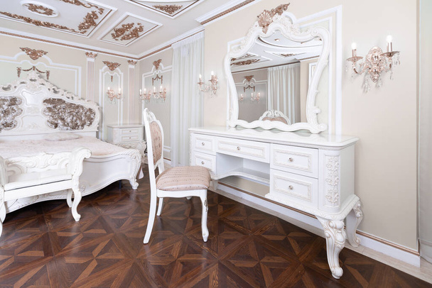 small luxury bedroom with bath and expensive furniture in a chic old baroque style. - Foto, imagen