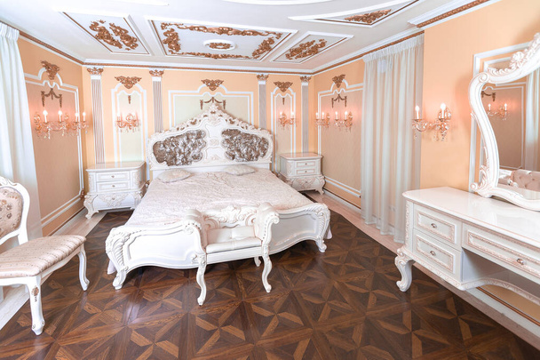 small luxury bedroom with bath and expensive furniture in a chic old baroque style. - Foto, imagen