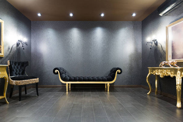 luxurious romantic room in a pompous style in black and gold colors with magnificent furniture - Fotó, kép