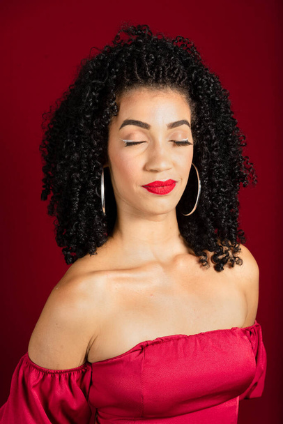 Close-up portrait of young beautiful woman with closed eyes. Isolated red background. - Foto, Bild