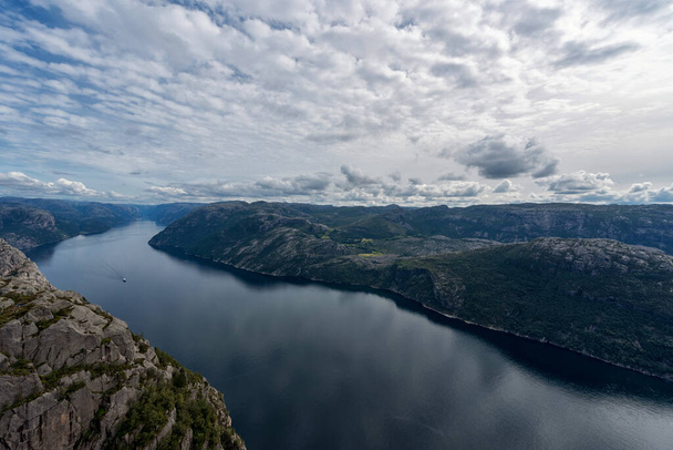 Norway Landscape. Preikestolen. River and Tourist Ferry in Background. Mountain. Blue sky. - Φωτογραφία, εικόνα