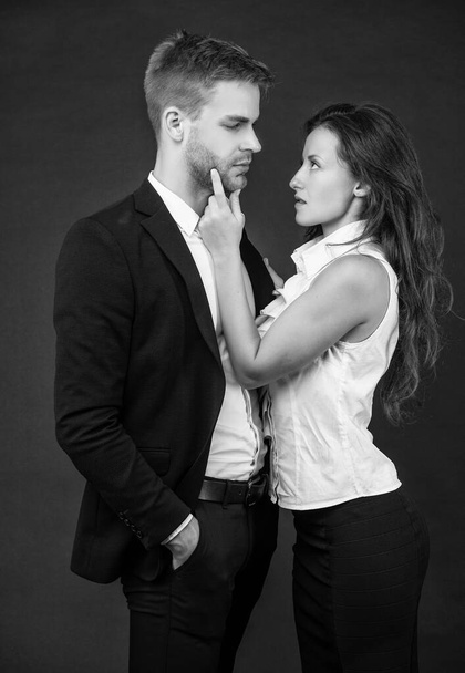 formal couple in love in business look on black background, businesspeople. - Fotoğraf, Görsel