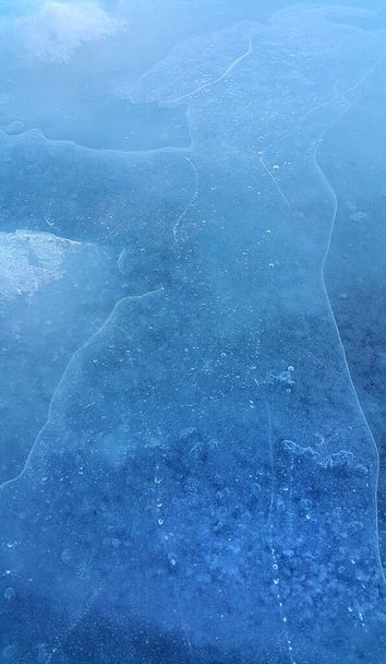 Brittle ice on the surface of a frozen river, close-up natural winter background - Foto, Imagem