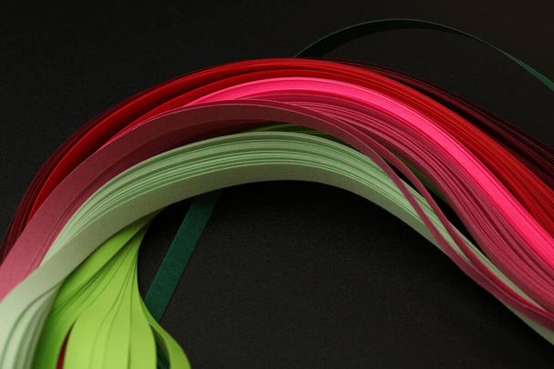 Pink and greent neon color strip wave paper. Abstract texture black background. - Fotografie, Obrázek
