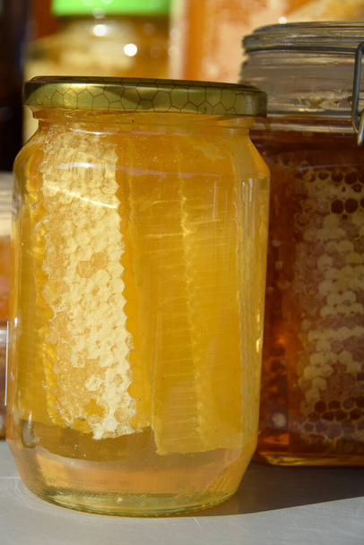 Honeycomb in a jars full of honey - Fotó, kép