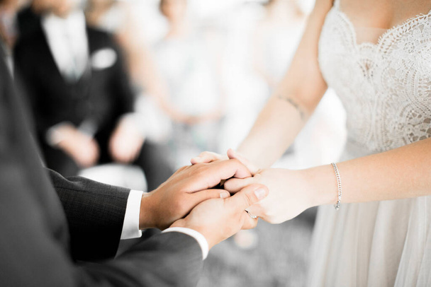 wedding rings on hands of bride and groom - Fotó, kép