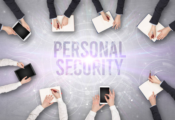 Group of people in front of a laptop with PERSONAL SECURITY insciption, web security concept - Photo, Image