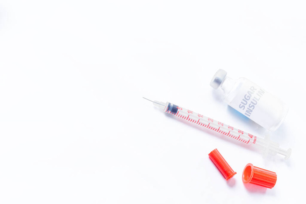Medical syringe and sugar insulin for diabetes on white background. Top view. - Photo, Image