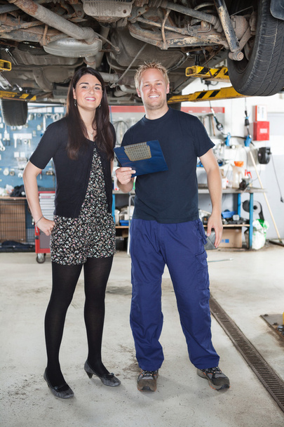 Portrait on mechanic and female customer - Фото, изображение