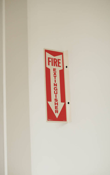 red and white emergency exit sign on a wall background - Fotografie, Obrázek