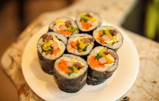 sushi rolls with salmon, avocado, cucumber and sesame. - 写真・画像