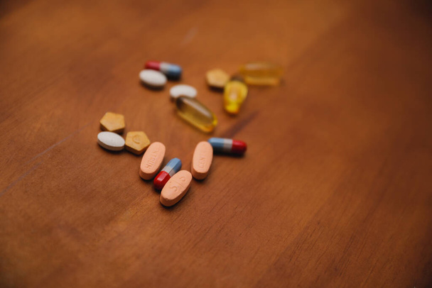pills and capsules on wooden background - Valokuva, kuva