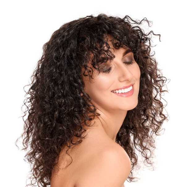 Beautiful young woman with long curly hair on white background - Foto, imagen