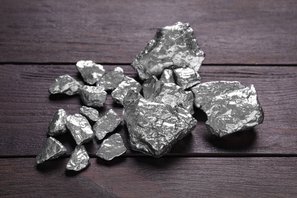 Pile of silver nuggets on wooden table - 写真・画像
