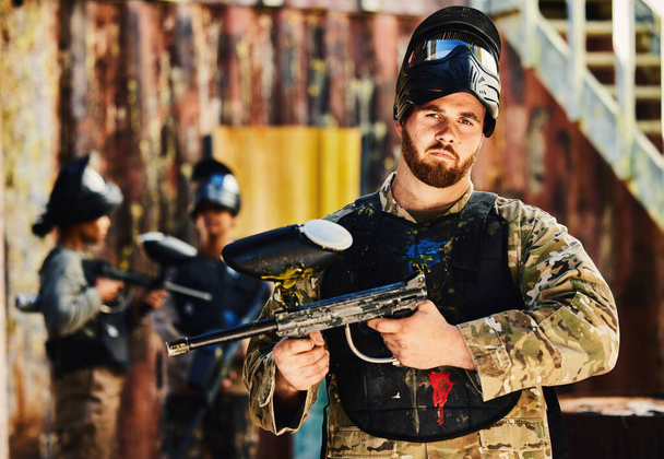 ペイントボール、アクション戦場ミッションでゲームをプレイシューティングゲームで銃を持つ男の深刻なまたは肖像画。生存中の武器装備を持つ戦争、英雄または焦点を当てた兵士軍事的挑戦競争. - 写真・画像