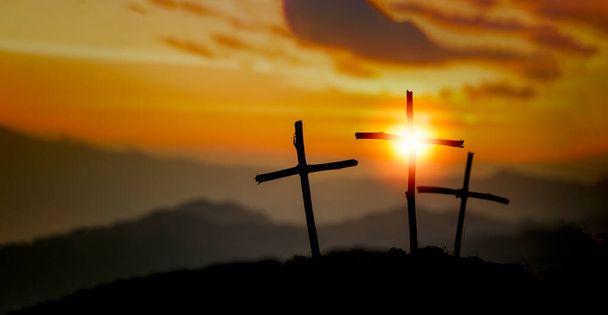 Crucifixion Of Jesus Christ - Cross At Sunset. The concept of the resurrection of Jesus in Christianity. Crucifixion on Calvary or Golgotha hills in holy bible. - Photo, Image