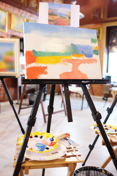 Easel with painting - 写真・画像