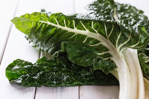 Bunch of silverbeet on a rustic wooden background - Foto, Imagen