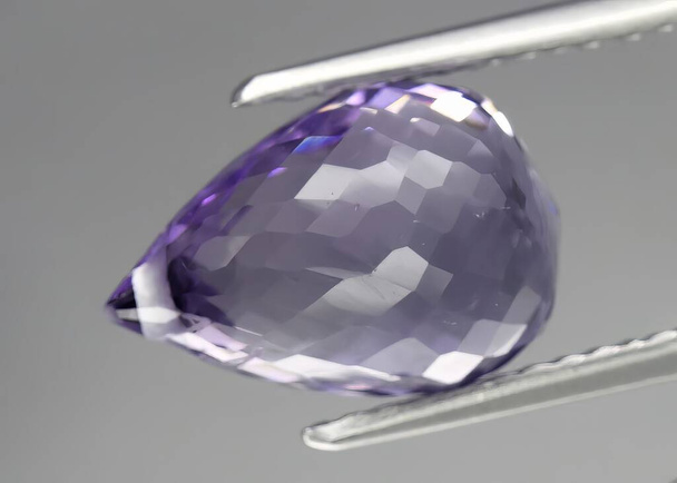 Natural gem purple amethyst on gray background - Foto, afbeelding