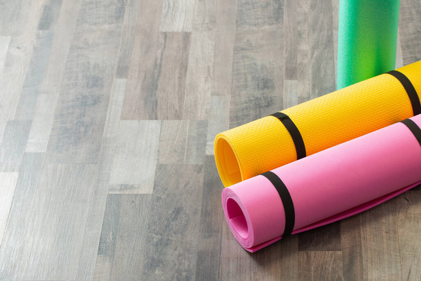 fitness mat on wooden floor at home - Foto, Imagen