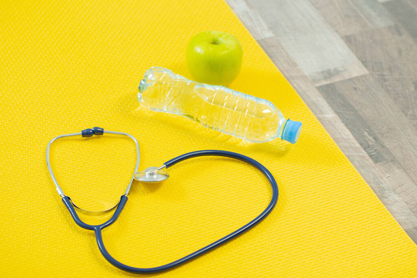 stethoscope on fitness mat, heart health concept - 写真・画像
