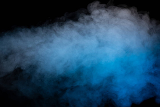 Blue and yellow steam on a black background. Copy space. - Photo, Image