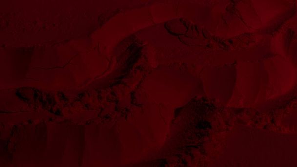 Red texture. Powder background. Pedra, sand. Red color. Dark red. Intense dark red. Cracks, waves, lines, circles, depressions. convex. Banner, advertising, for inscription - Фото, изображение