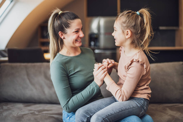 Happy mother and daughter enjoy spending time together at their home. - Valokuva, kuva