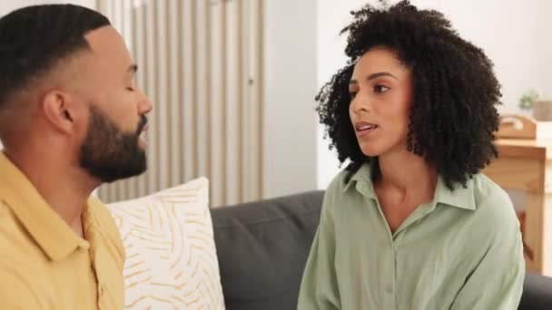 Argue, disagree and unhappy with a black couple talking in the living room of their home during a discussion. Communication, conversation and angry with a man and woman arguing on a sofa in the house. - Záběry, video