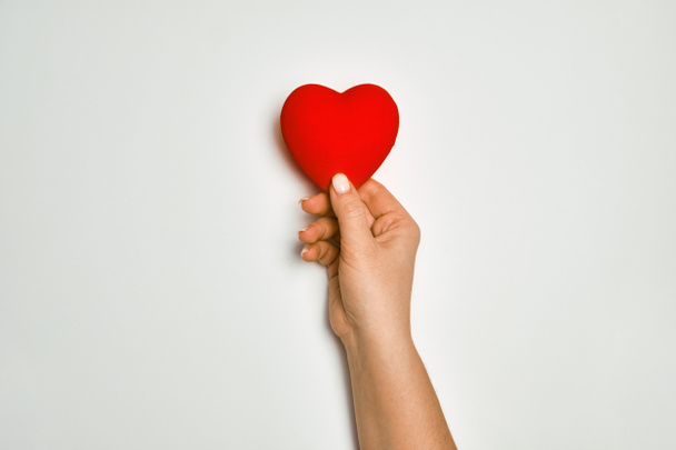 hands holding red heart, health care, love, organ donation, mindfulness, wellbeing, family insurance and CSR concept, world heart day, world health day, world mental health day, praying concept - Photo, Image