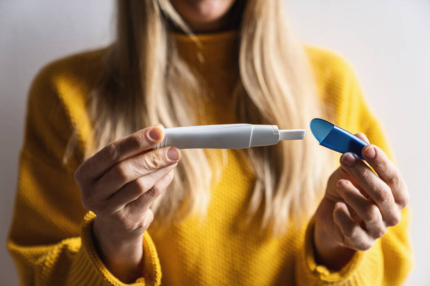 Close-up de uma mulher fechar um teste de plástico rápido gravidez que confirmam que ela está provavelmente grávida. Nova vida, saúde feminina, mudanças felizes e imagem conceito de fertilização - Foto, Imagem
